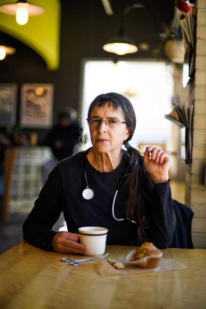 Midwife with a cup of coffee and a muffin